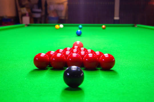 Blackball rack set for the break on a green cloth table
