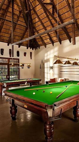 Pool tables under warm lighting in a South African clubhouse